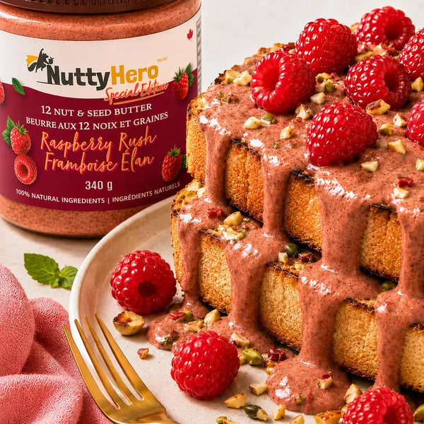 Waffle cake with raspberry nut butter and raspberries on a plate next to a jar of NuttyHero butter.